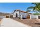 Single-story house with white exterior, tile roof, palm trees, and a long driveway at 1809 E Gwen St, Phoenix, AZ 85042