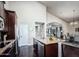 Modern kitchen with granite countertops and island with seating, connecting to dining area at 1809 E Gwen St, Phoenix, AZ 85042