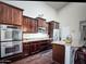 Spacious kitchen with stainless steel appliances, wood cabinets, and granite countertops at 1809 E Gwen St, Phoenix, AZ 85042