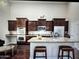 Kitchen with dark cabinets, granite countertops, and stainless steel appliances at 1809 E Gwen St, Phoenix, AZ 85042