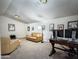 Comfortable living room featuring a leather sofa, workstation, and decorative artwork at 1809 E Gwen St, Phoenix, AZ 85042