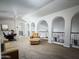 Inviting living room with tan leather furniture, neutral carpet, and architectural arches at 1809 E Gwen St, Phoenix, AZ 85042