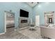 Airy living room with blue walls, fireplace, vaulted ceiling, and stylish gray furniture on tile floors at 1809 E Gwen St, Phoenix, AZ 85042