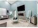 Airy living room with blue walls, fireplace, vaulted ceiling, and stylish gray furniture on tile floors at 1809 E Gwen St, Phoenix, AZ 85042