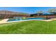 This backyard features an inground pool, a lush lawn, and mature landscaping at 1809 E Gwen St, Phoenix, AZ 85042