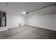 Bright garage featuring modern lighting, clean floors, and plenty of storage space at 18260 W Daley Ln, Surprise, AZ 85387
