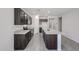 Modern kitchen featuring dark cabinetry, granite countertops, and stainless steel appliances at 18260 W Daley Ln, Surprise, AZ 85387