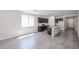 Spacious open floor plan featuring an open kitchen and grey wood-look tile at 18260 W Daley Ln, Surprise, AZ 85387