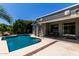 Inviting backyard with a sparkling pool, patio, and lush landscaping creates a private oasis at 18459 E Ranch Rd, Queen Creek, AZ 85142