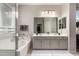 Bathroom boasts a double sink vanity, bathtub, and direct access to the walk-in closet at 18459 E Ranch Rd, Queen Creek, AZ 85142