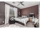 Bedroom with modern ceiling fan, dark walls, and a window with natural lighting at 18459 E Ranch Rd, Queen Creek, AZ 85142