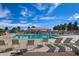 Large community pool surrounded by lounge chairs, perfect for relaxing and socializing at 18459 E Ranch Rd, Queen Creek, AZ 85142