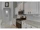 Bright kitchen featuring stainless steel appliances and white cabinetry with modern countertops at 18459 E Ranch Rd, Queen Creek, AZ 85142