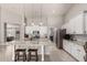 Bright kitchen featuring a spacious island, stainless steel appliances, and white cabinetry at 18459 E Ranch Rd, Queen Creek, AZ 85142