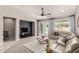 Cozy living room featuring plush seating, neutral decor, and a sliding glass door for natural light at 18459 E Ranch Rd, Queen Creek, AZ 85142