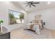 Cozy bedroom with a large window and modern ceiling fan at 18812 N 90Th Pl, Scottsdale, AZ 85255