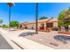 This street view shows single-story homes with brick accents, desert landscaping, and palm trees at 2105 S Zinnia Ave # 468, Mesa, AZ 85209