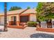 A lovely one-story home that features a two-car garage, brick accents, and tidy desert landscaping at 2105 S Zinnia Ave # 468, Mesa, AZ 85209
