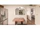 Bright view from the dining area into the kitchen, stainless steel fridge, and breakfast table at 2105 S Zinnia Ave # 468, Mesa, AZ 85209