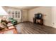 Living area featuring wood-look flooring, comfortable seating, and sunny shuttered windows at 2105 S Zinnia Ave # 468, Mesa, AZ 85209