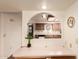 Open living room with a view into the kitchen, featuring a built-in desk and hardwood floors at 2105 S Zinnia Ave # 468, Mesa, AZ 85209