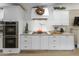 Modern kitchen features stainless steel appliances, sleek cabinetry, and a tiled backsplash at 2111 W Mulberry Dr, Phoenix, AZ 85015