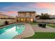 A lush backyard with a sparkling pool and a welcoming seating area at 21665 N 47Th Pl, Phoenix, AZ 85050