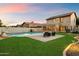Beautiful backyard with a pool, an outdoor seating area, and well-maintained landscaping at 21665 N 47Th Pl, Phoenix, AZ 85050