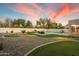 An expansive backyard featuring a putting green, pool, and comfortable seating at 21665 N 47Th Pl, Phoenix, AZ 85050