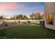 A picturesque backyard with a putting green, pool, and inviting seating area at 21665 N 47Th Pl, Phoenix, AZ 85050