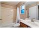 Standard bathroom with a shower-tub combo, vanity and bright lighting at 21665 N 47Th Pl, Phoenix, AZ 85050