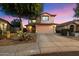Charming two-story home featuring a neutral exterior, two-car garage, and mature desert landscaping at 21665 N 47Th Pl, Phoenix, AZ 85050