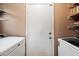Laundry room with a washer, dryer and some shelving for storage at 21665 N 47Th Pl, Phoenix, AZ 85050