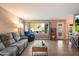 Comfortable living room with tile floors, a large window overlooking the backyard and a comfortable sofa at 21665 N 47Th Pl, Phoenix, AZ 85050