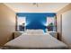 Main bedroom featuring a ceiling fan, windows and a bold accent wall at 21665 N 47Th Pl, Phoenix, AZ 85050