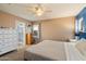 Spacious bedroom with a ceiling fan, lots of natural light, carpeted floors and an ensuite bathroom at 21665 N 47Th Pl, Phoenix, AZ 85050