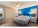 Main bedroom featuring a ceiling fan, windows and a bold accent wall at 21665 N 47Th Pl, Phoenix, AZ 85050