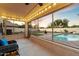 Enclosed patio with string lights overlooking a pool and putting green at 21665 N 47Th Pl, Phoenix, AZ 85050