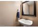Powder room features a pedestal sink, framed mirror, and neutral paint at 21665 N 47Th Pl, Phoenix, AZ 85050