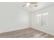 Well-lit bedroom with wood-look flooring, ceiling fan, and window at 2402 E 5Th St # 1457, Tempe, AZ 85288