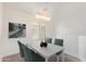 A well-lit dining room features a modern chandelier and stylish table with seating for four at 2402 E 5Th St # 1457, Tempe, AZ 85288