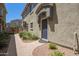 View of the exterior featuring a blue front door and well-maintained landscaping at 1457 at 2402 E 5Th St # 1457, Tempe, AZ 85288