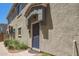 Close up of the front door with textured exterior, walkway and tidy landscaping at 1457 at 2402 E 5Th St # 1457, Tempe, AZ 85288
