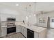 Modern open kitchen with quartz countertops, stainless appliances, and dining area at 2402 E 5Th St # 1457, Tempe, AZ 85288