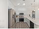 Bright kitchen boasts stainless steel appliances, white cabinets, and quartz countertops at 2402 E 5Th St # 1457, Tempe, AZ 85288