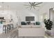Bright, staged living room featuring neutral colors, modern ceiling fan, and open layout to the kitchen at 2402 E 5Th St # 1457, Tempe, AZ 85288