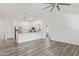 Spacious living area featuring hardwood floors, ceiling fan, and open kitchen concept at 2402 E 5Th St # 1457, Tempe, AZ 85288