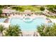 Aerial view of a community pool with lounge chairs and a hot tub surrounded by lush landscaping and shaded areas at 2402 E 5Th St # 1457, Tempe, AZ 85288