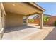 Covered back patio and low maintenance yard with a block wall at 25945 W Runion Dr, Buckeye, AZ 85396