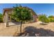 Backyard with gravel, small trees, and covered patio area at 25945 W Runion Dr, Buckeye, AZ 85396